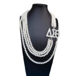 FOUR STRAND PEARL NECKLACE WITH SYMBOLS